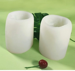 Detail of two white cylindrical silicone molds for DIY animal candles and soaps