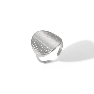 Macro view of adjustable stainless steel ring with irregular hammered texture surface