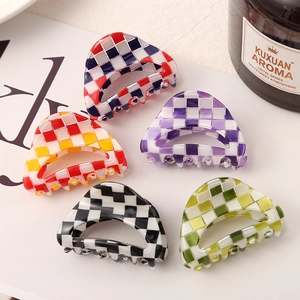 Detailed view of five checkered hair claw clips in various colors with a sleek arch design