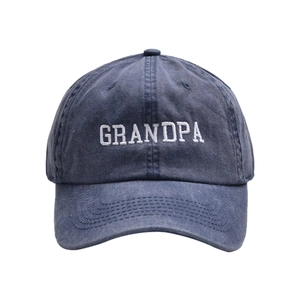 Close-up of white GRANDPA embroidery on washed navy blue cotton twill baseball cap