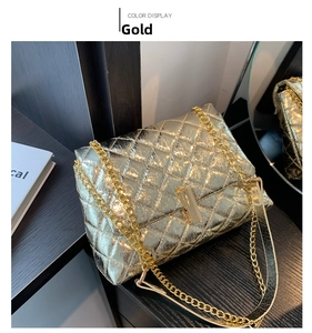 Detail of gold chain strap and rhombic quilted metallic finish on fashion bag