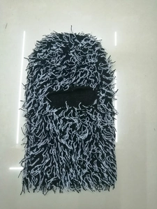 Detailed close-up of the black and white faux fur texture on a warm balaclava mask