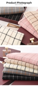 Close-up of high-quality plaid scarf fabric texture and delicate fringe with gift box
