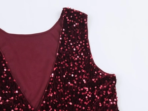 Macro detail of wine red sequins on fabric with V-neckline stitching and lining