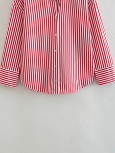 Detail of red and white striped poplin shirt with button front and curved hemline