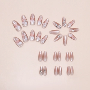 Macro view of cat-eye press-on nails with 3D crystal lilies and rhinestone details