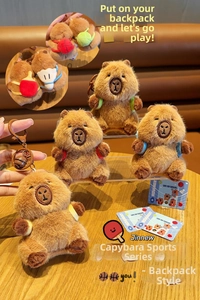 Detail of colorful plush capybara bag charms with sports accessories and bells