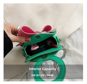 Macro view showing internal capacity for lipstick and compact powder in green bow bag