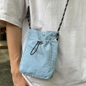 Waterproof nylon crossbody water bottle bag with drawstring in light blue sport style