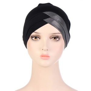 Detailed front view of elastic turban hat with silver cross-knot mesh on black fabric