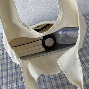 Detail view of large canvas tote bag interior showing capacity for laptop and books