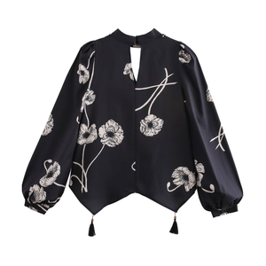 Vintage floral print shirt with hollow back lantern sleeves and tassel details on white background