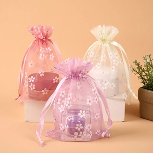 Pink beige and purple organza drawstring bags with gold cherry blossom prints