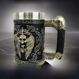 Close-up of gothic silver skull with wings relief on a resin dragon sword wine goblet