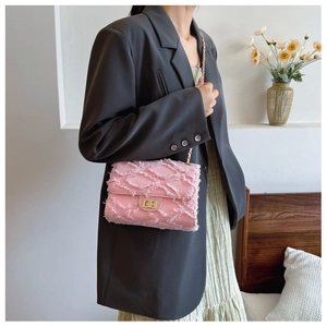 Pink tweed crossbody bag featuring a golden chain strap and vintage square twist lock
