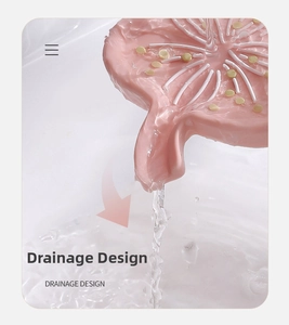 Pink lotus-shaped silicone soap dish featuring a built-in drainage spout for dry counters