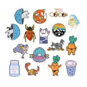 Collection of assorted cartoon enamel pins including animals, carrots and space themes