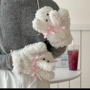 Détail de mitaines blanches en peluche avec nœuds roses et cordon de cou pratique