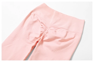 Detailed close-up of light pink high waisted yoga pants with scrunch butt lifting design