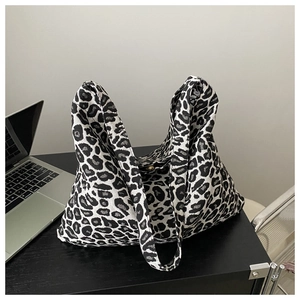 Close-up of a large capacity canvas tote bag with black and white leopard print pattern