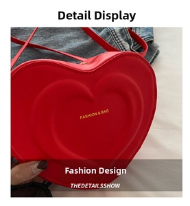 Close-up of red heart-shaped PU leather crossbody bag with embossed double heart design