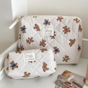 Set of two quilted striped bear cosmetic bags with zippers for travel organization