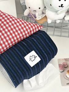 Detail of red checkered tissue holder with cute cat label and house-shaped fabric design