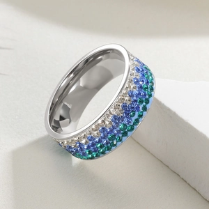 Macro shot of 8mm wide stainless steel ring with five rows of multicolored crystals