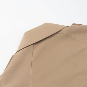Detailed close-up of khaki trench coat collar with high-density twill fabric and stitching