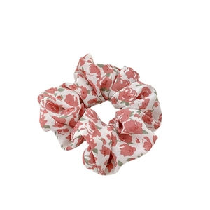 Floral print fabric scrunchie with pink flowers on white background for ponytails