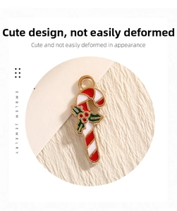 Detail of candy cane alloy pendant with enamel Christmas holly leaves for DIY jewelry