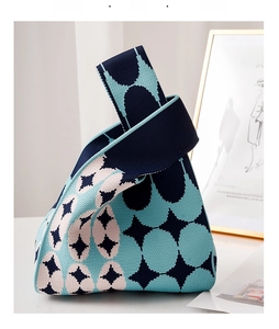 Detailed knit knot bag with geometric star pattern and navy pink color-blocking