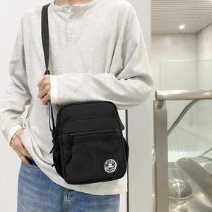 Minimalist black square crossbody bag with mesh pockets and multi-zipper compartments