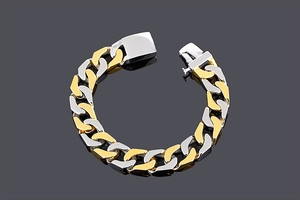 Detail of two-tone gold and silver stainless steel curb chain bracelet with square clasp