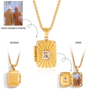 Macro detail of a gold tarot-style locket necklace showing open and reverse views