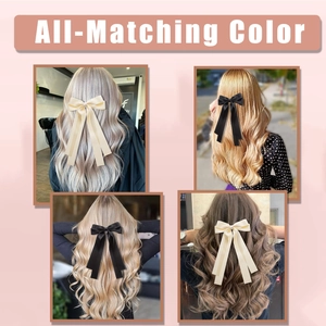 Detail of long double-layer satin ribbon bow clips in classic black and cream white