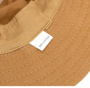 Macro shot of 100% cotton washing label and neat stitching on khaki outdoor hat