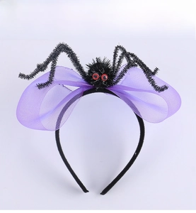 Detail of purple mesh bow headband with a fuzzy black spider and red eyes for Halloween