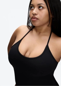 Close-up of a black halter neck tank top featuring elastic knitted fabric and slim straps