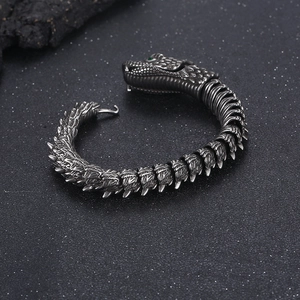 Close-up of vintage dragon bracelet with green gem eyes and textured scales