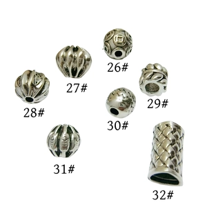 Various styles of silver-tone spacer beads for jewelry making with unique textured patterns