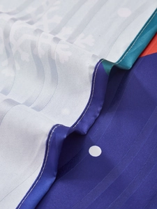 Macro detail of Christmas curtain fabric showing blue satin texture and fine edge stitching