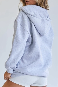 Side view of oversized light grey cotton hoodie showing loose fit and premium fabric texture