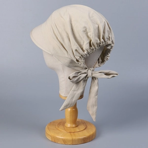 Detail of beige cotton sun hat featuring adjustable back elastic and a large decorative bow