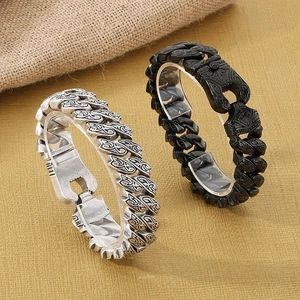 Macro view of retro stainless steel men's bracelets with tribal engraved textures
