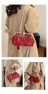 Detail of red Chinese style embroidery bag with pearl chain and silk tassel decoration