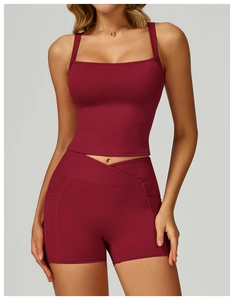 Detail shot of wine red high-waist yoga shorts featuring side pockets and cross-waist design