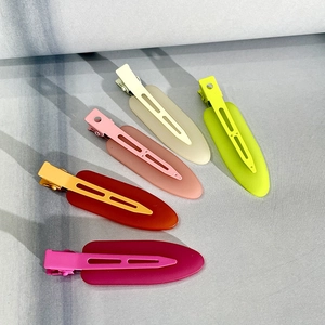 Detail showing five colorful matte finish hair clips in various vibrant pastel shades
