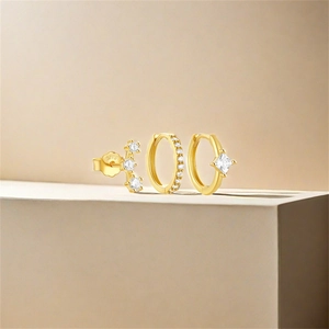Detail of s925 silver gold-plated earring set featuring zircon studs and hoops with S925 stamp