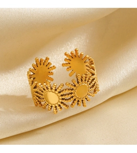 Macro detail of 18K gold plated sun flower open ring on champagne silk background